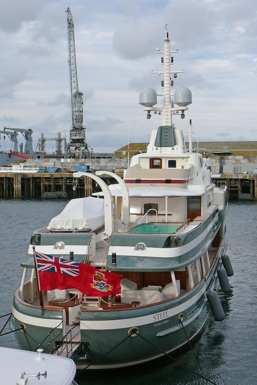 a big white boat docked at a large pier