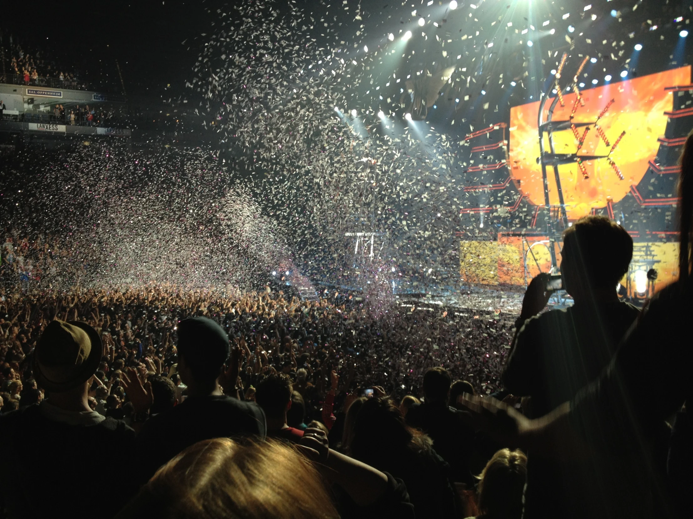 a large crowd of people with bright fireworks