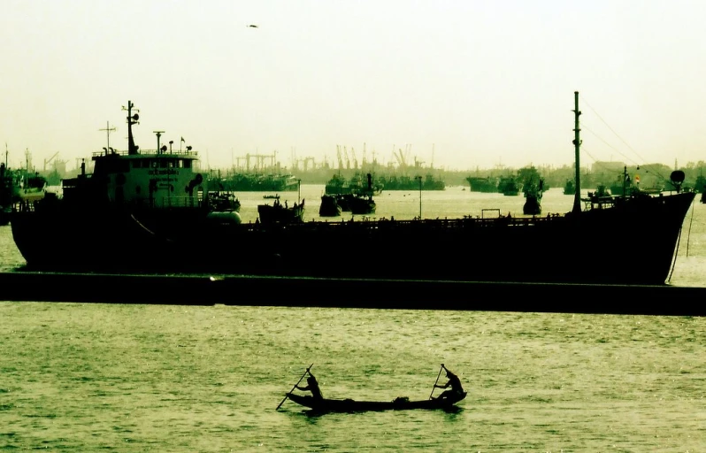 two people in a small boat on the water