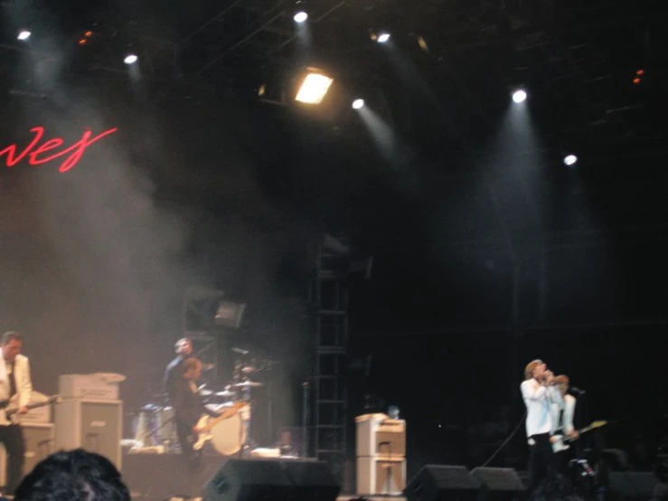 two men standing on a stage with their hands in the air