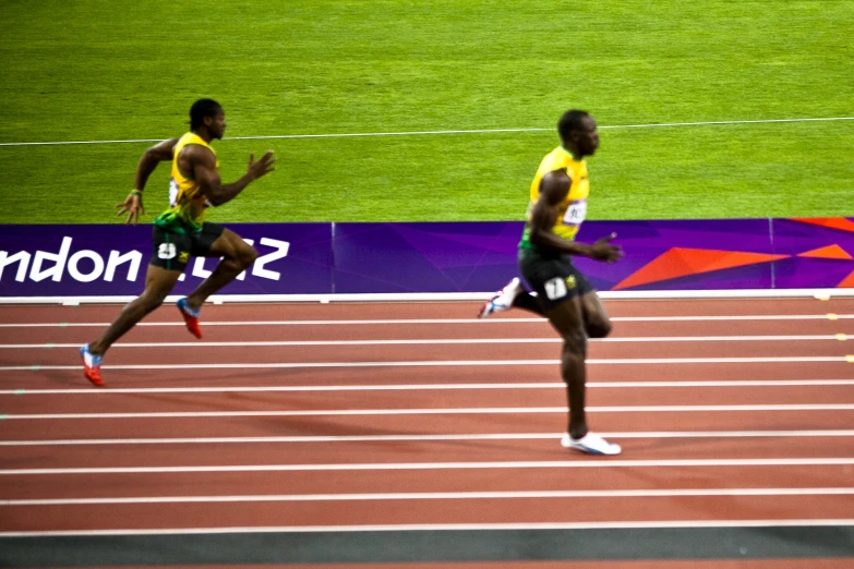 a group of men that are running on a track
