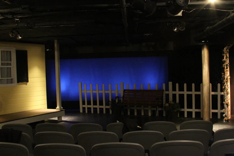 a big blue screen with a wood bench