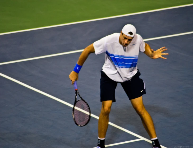 a tennis player is waiting for the ball to come down