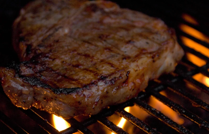 a steak is cooking on the grill on the grill