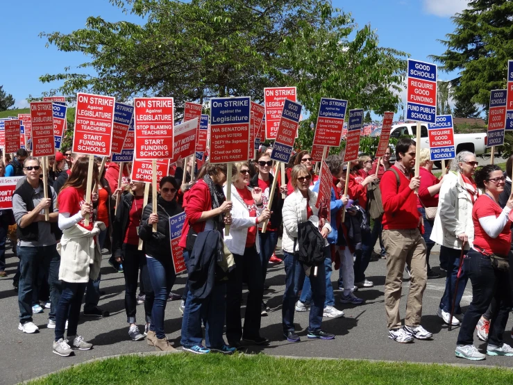 a large group of people holding up signs