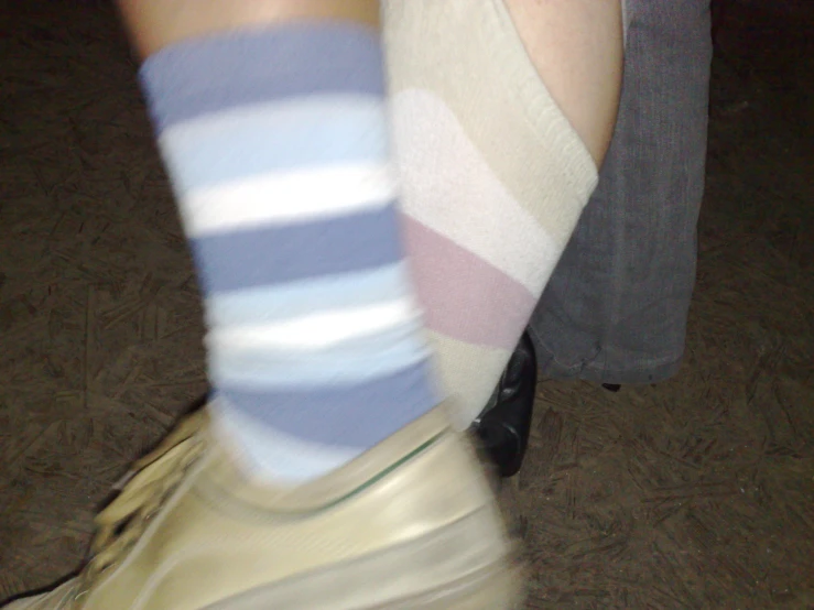 a close up of a woman in white socks and blue striped socks