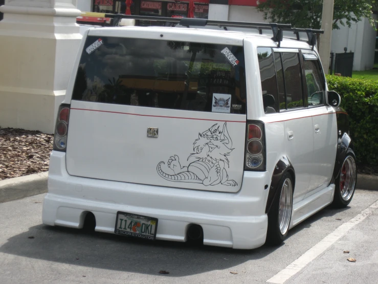 a small white van parked on the side of the road