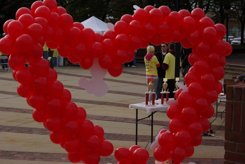 red balloons are arranged in a heart shape