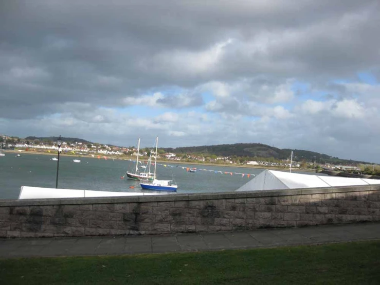 the ocean with sailboats in it is calm