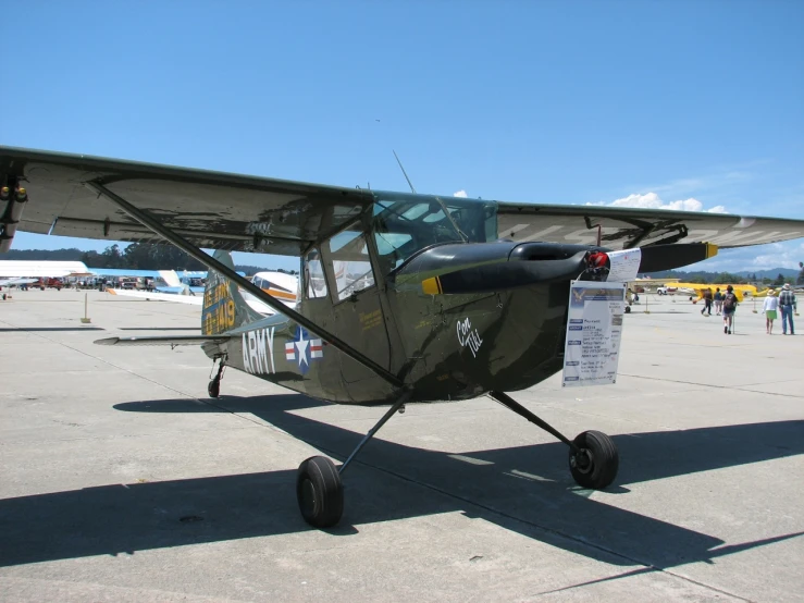 a prop plane sitting on a tarmac at an airport