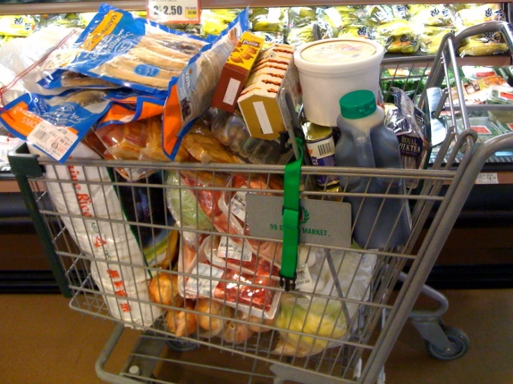 a grocery cart full of food and drinks