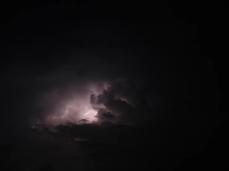 a lightning strike in the distance on a dark night