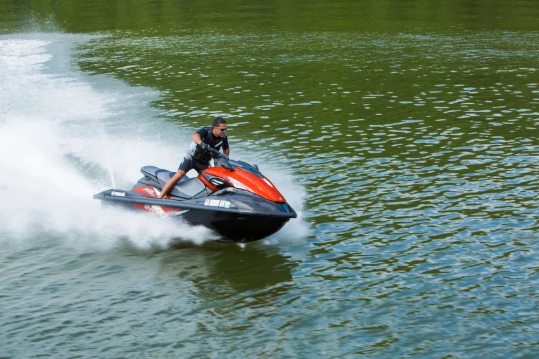 a man is driving a jet ski through the water