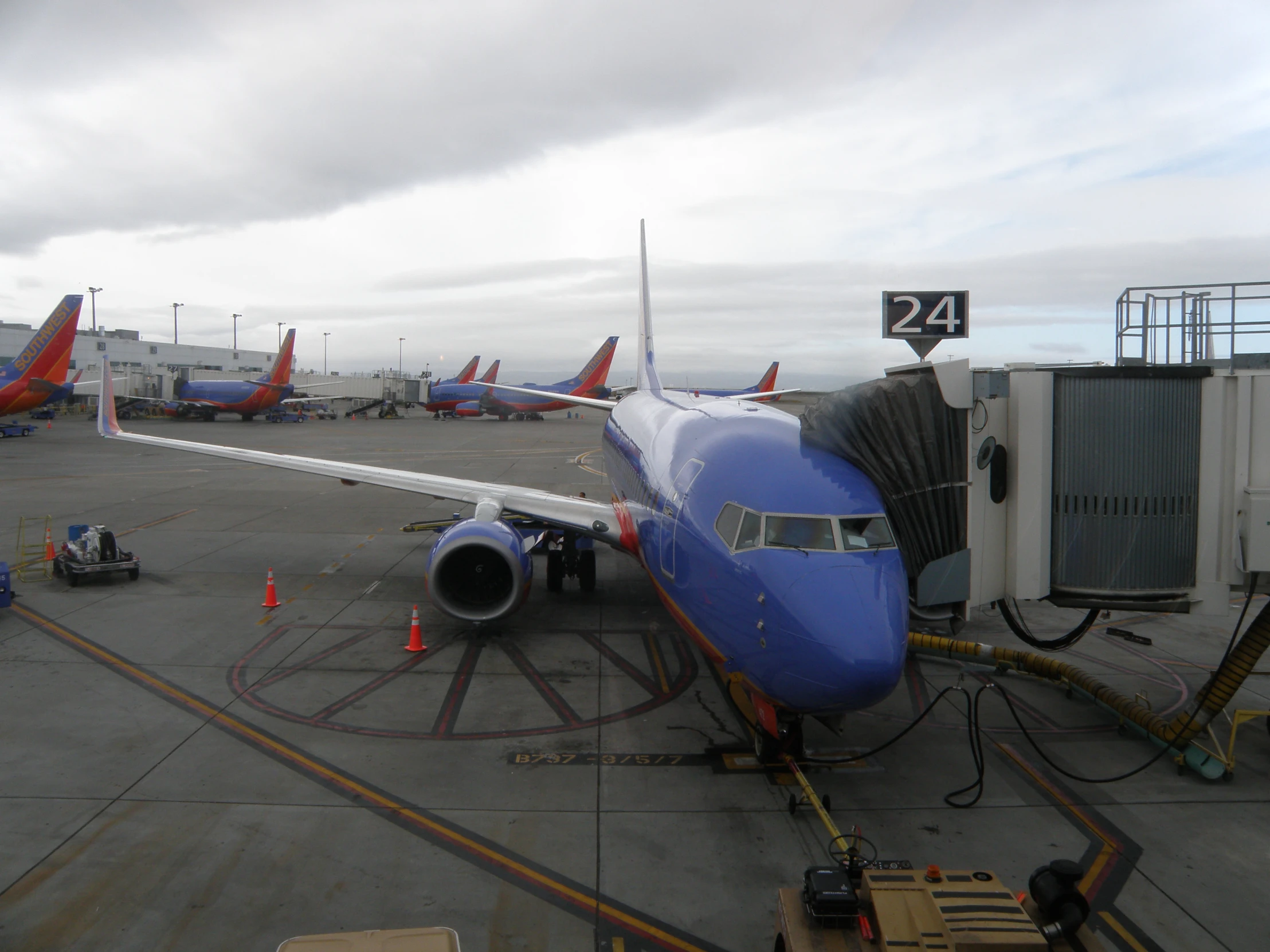 an airplane sitting on the tarmac and getting refueled