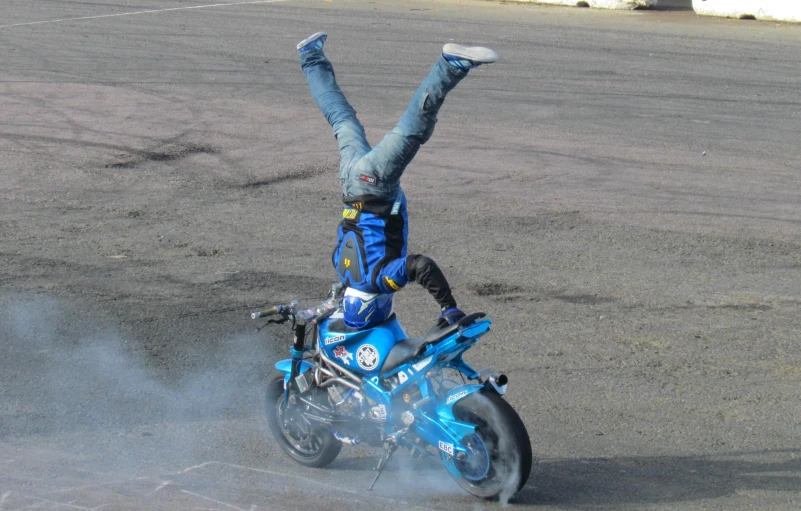 a person in jeans and a t - shirt is riding on a motorcycle