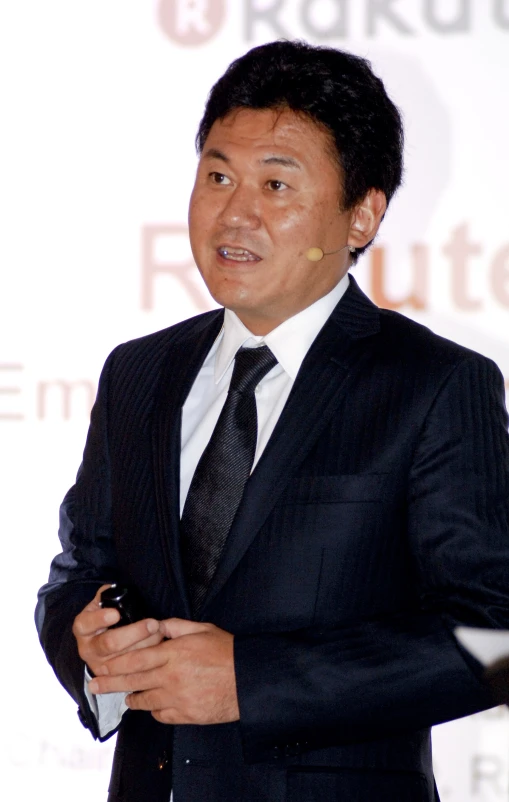 asian businessman giving an speech at a podium