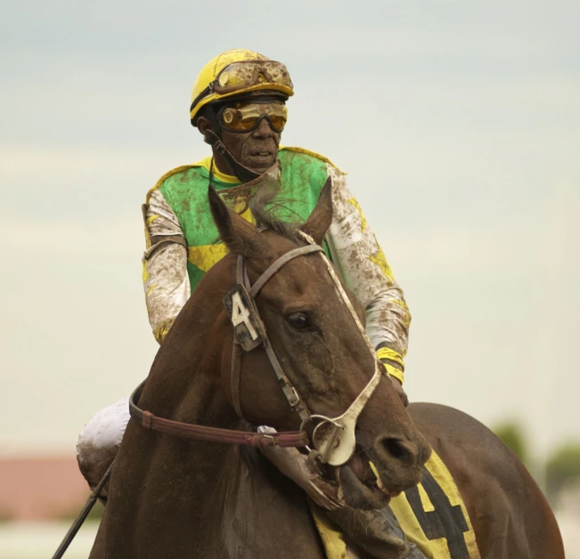 a man riding a horse wearing a hat