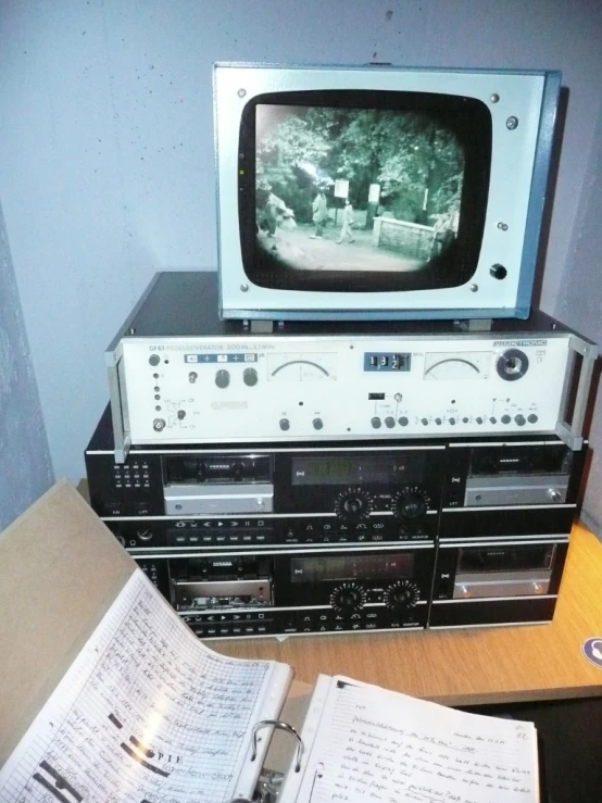 a wooden table with books and a television on top of it