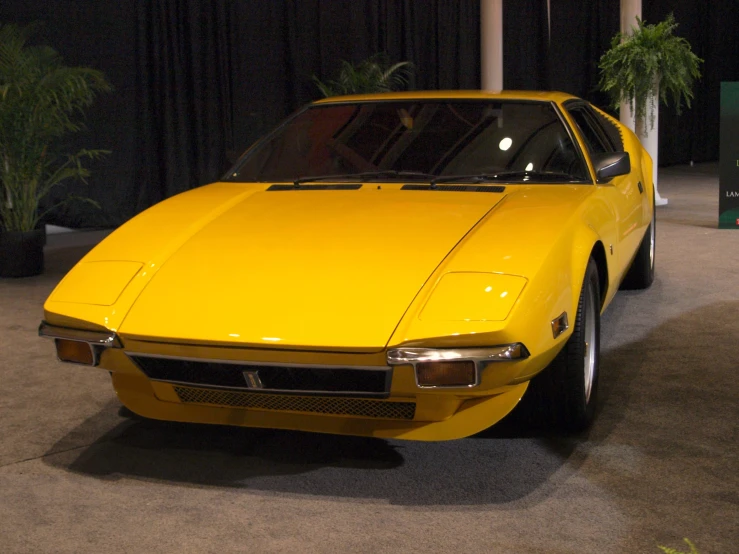 a car is yellow in color and on display