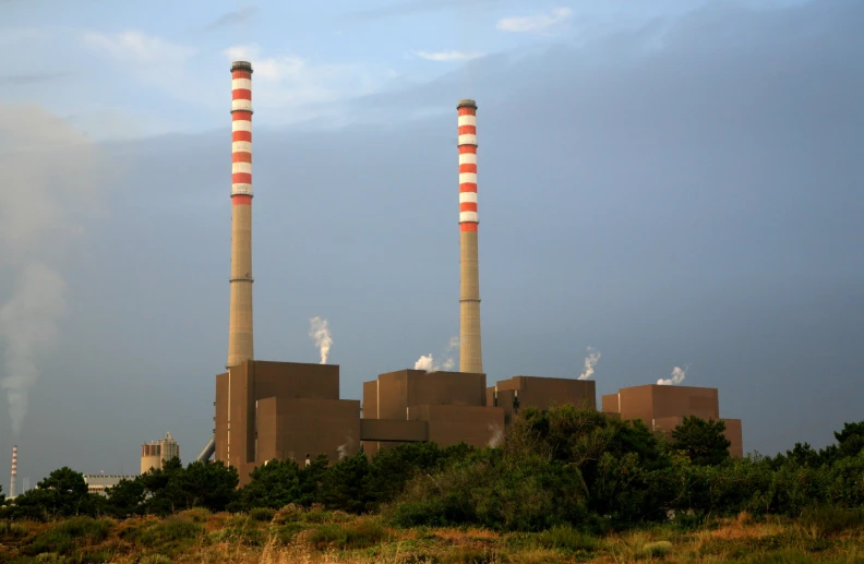 some chimneys are standing out in the sky