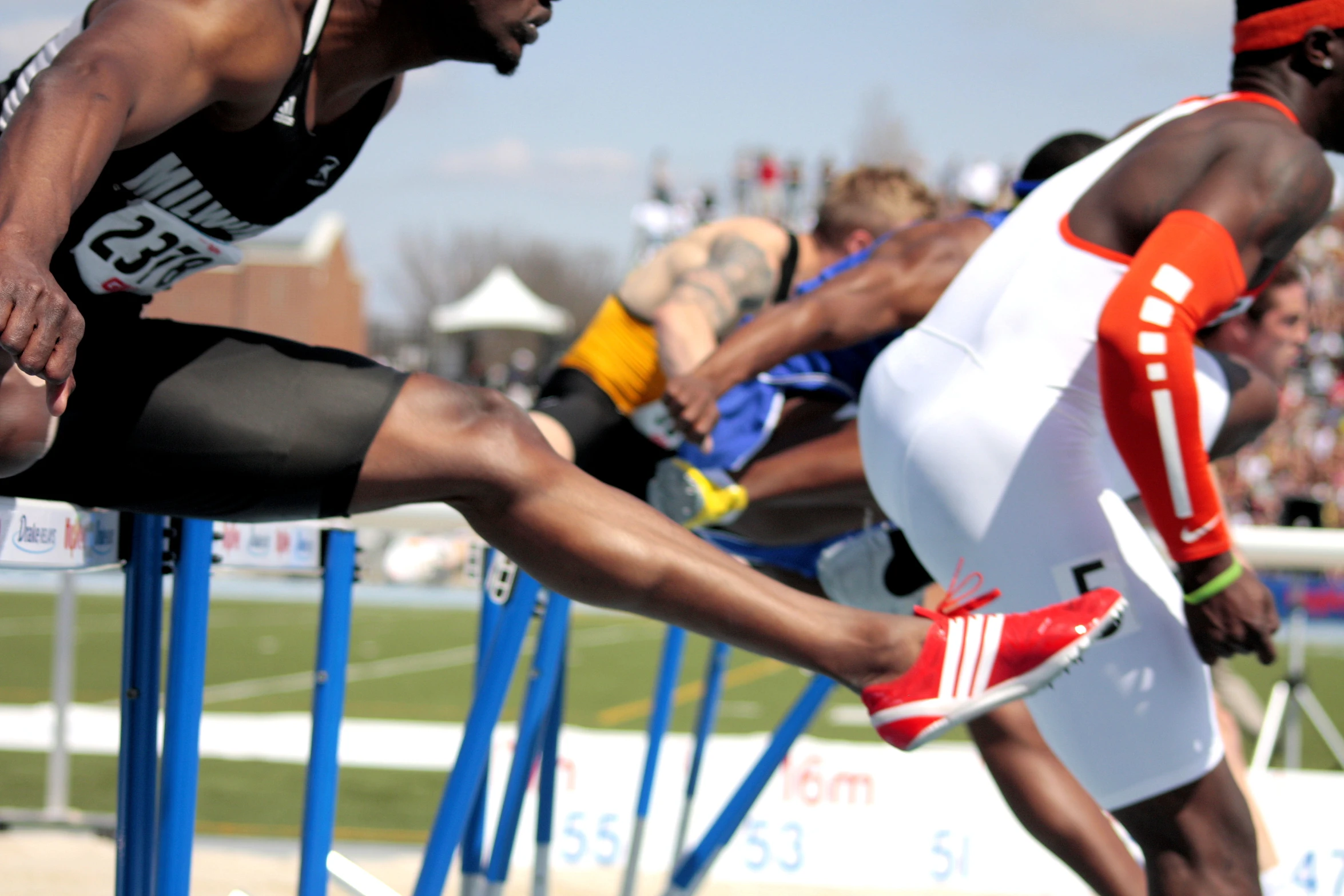 two athletes are sprinting on an obstacle course