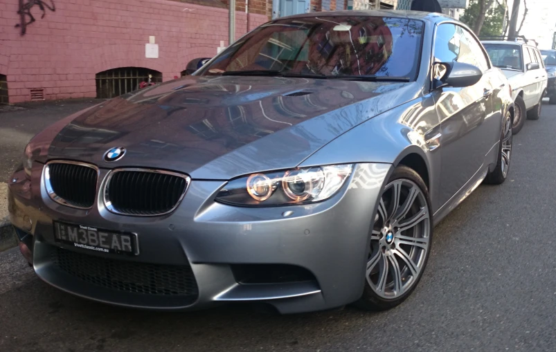 silver car parked near a curb near buildings