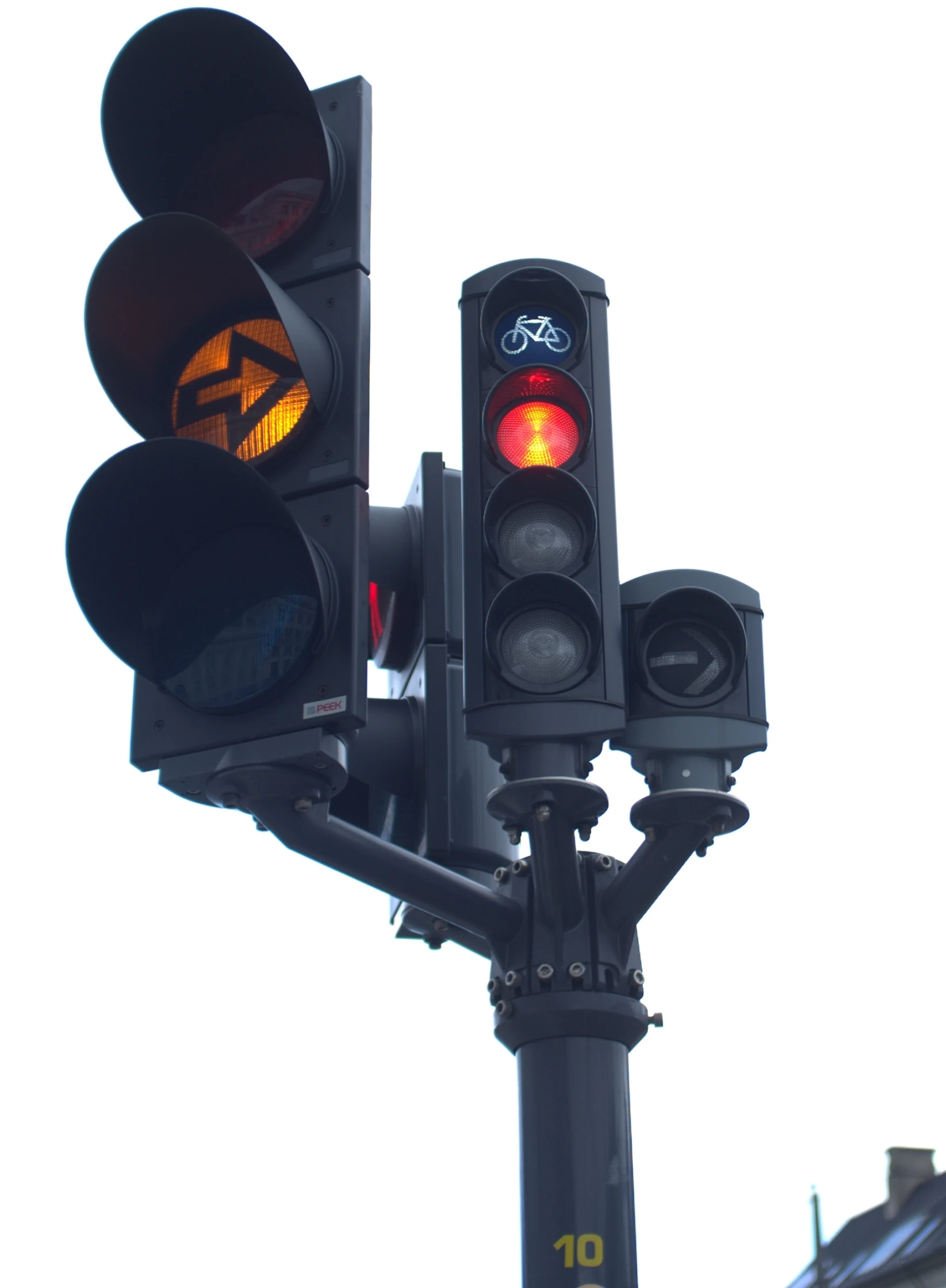 a red stop light with street signs attached