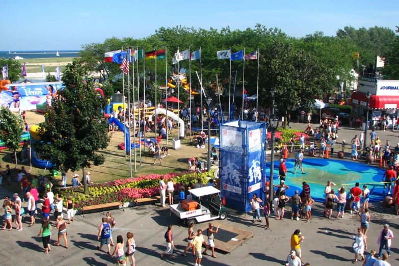 a crowd of people are gathered to enjoy an outdoor festival