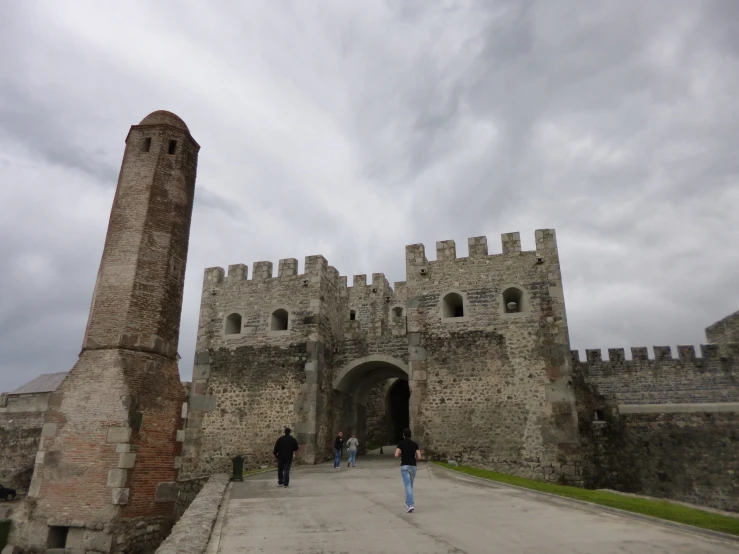 a large gate leading into a stone castle