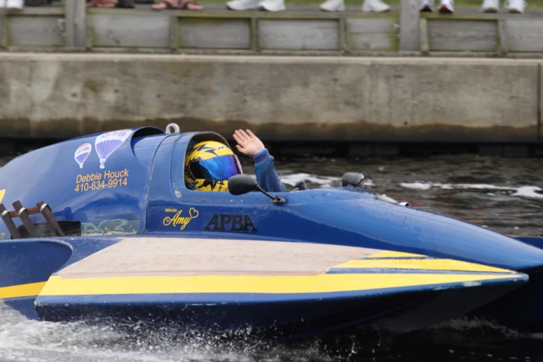 a blue boat filled with people riding it's wheels