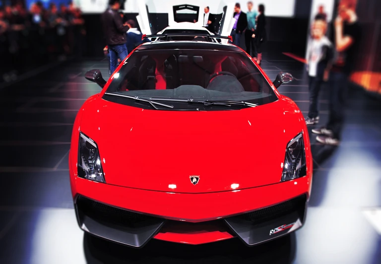 a sports car with a top down, at an auto show