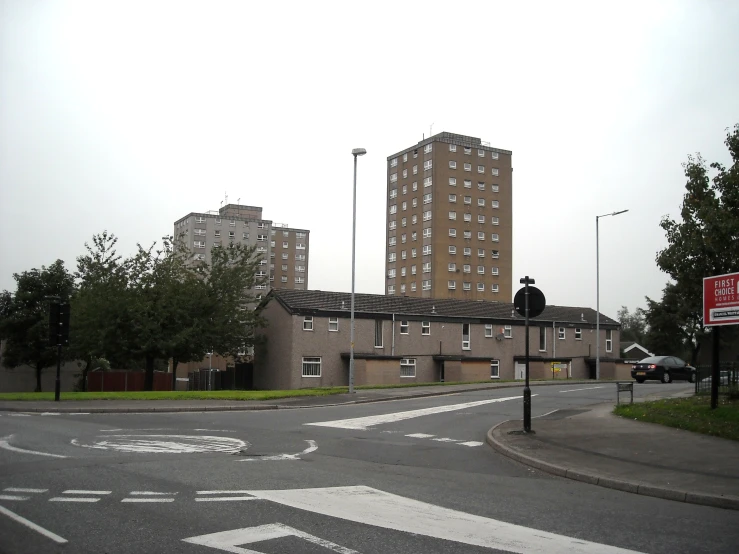 a view of an empty street with two buildings in the distance