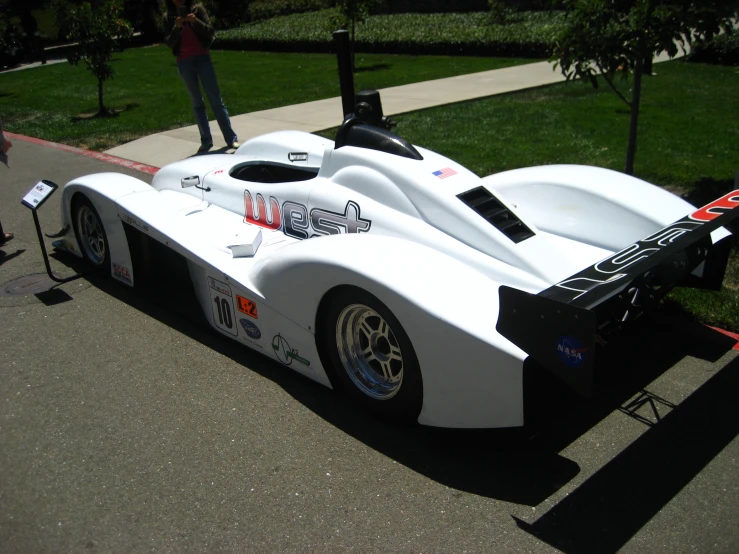 the front view of a race car parked on the side of a road