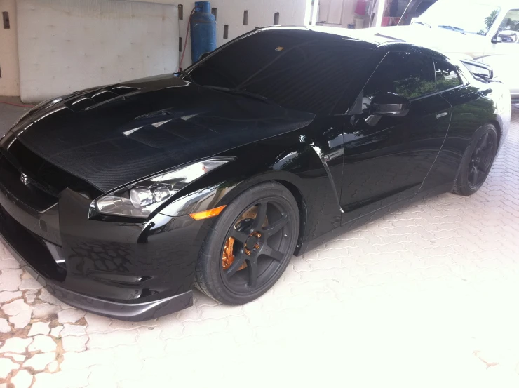 a black car is parked in the garage