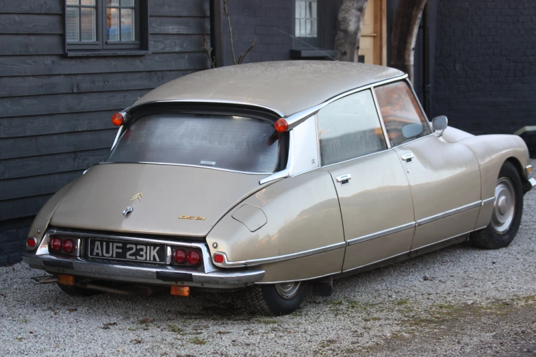 this car is parked outside an old house