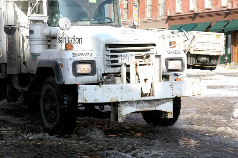 a large white truck parked in front of a building