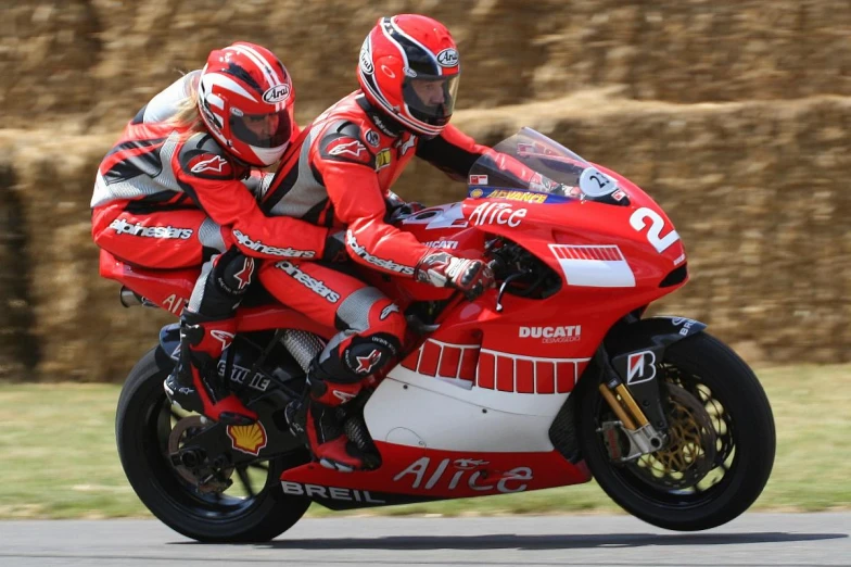 two men racing motorcycles on a track