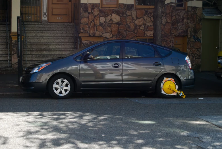 a car parked in front of a house near a street