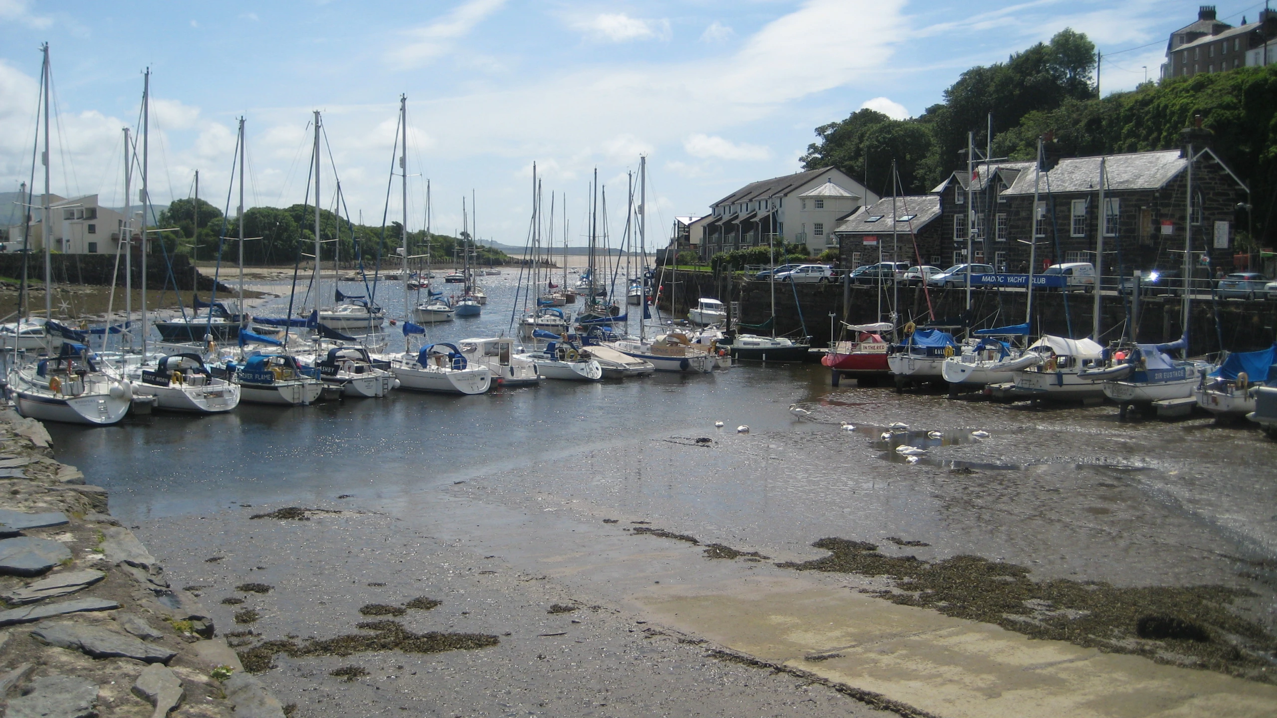 several boats sitting at docks near buildings