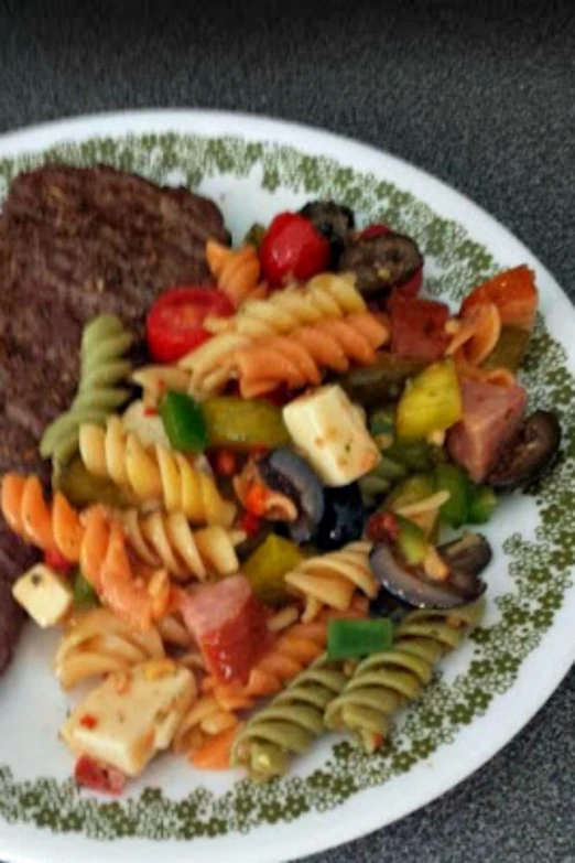 a big plate full of some noodles and meat