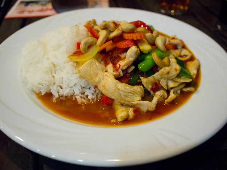 this meal includes chicken, rice, and a vegetable stew