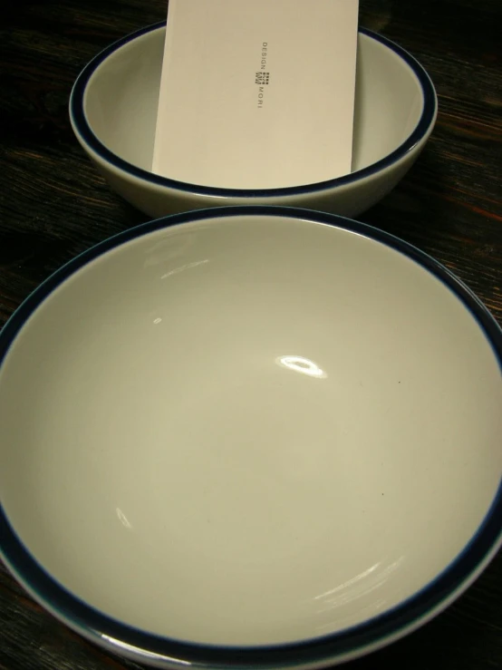 two white and blue dishes on a wooden table