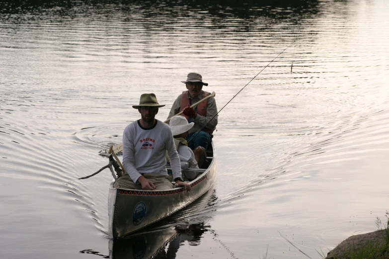 two men sit in their boats on the water