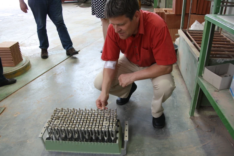 a man bending over looking at a case