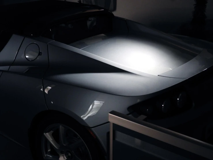 a car parked inside a garage, with the hood open