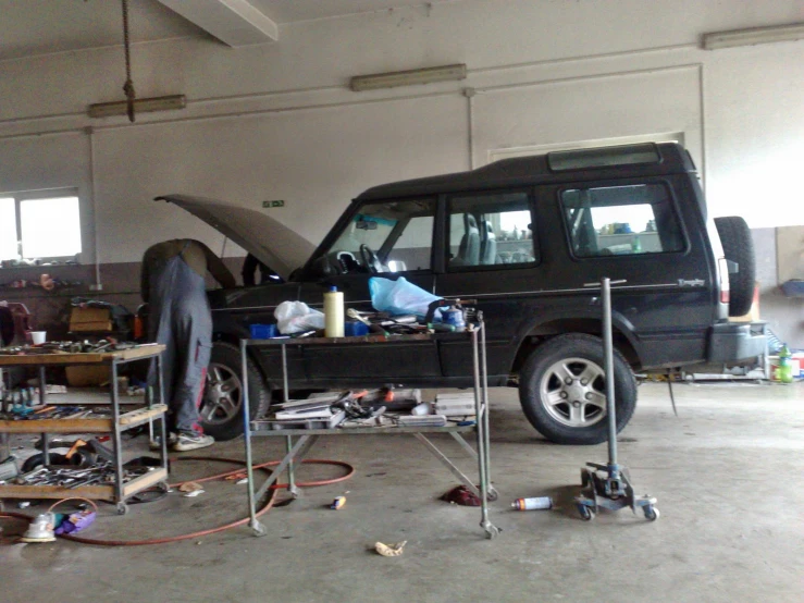 car sitting in workshop with a few people