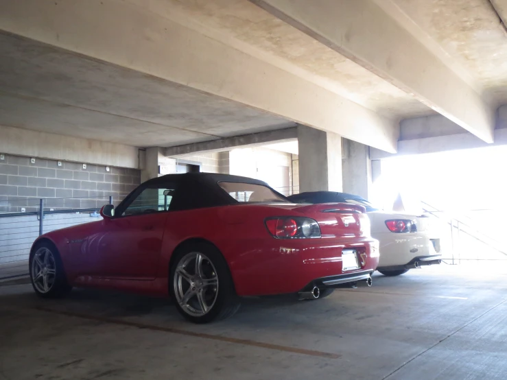 two cars parked inside a garage together