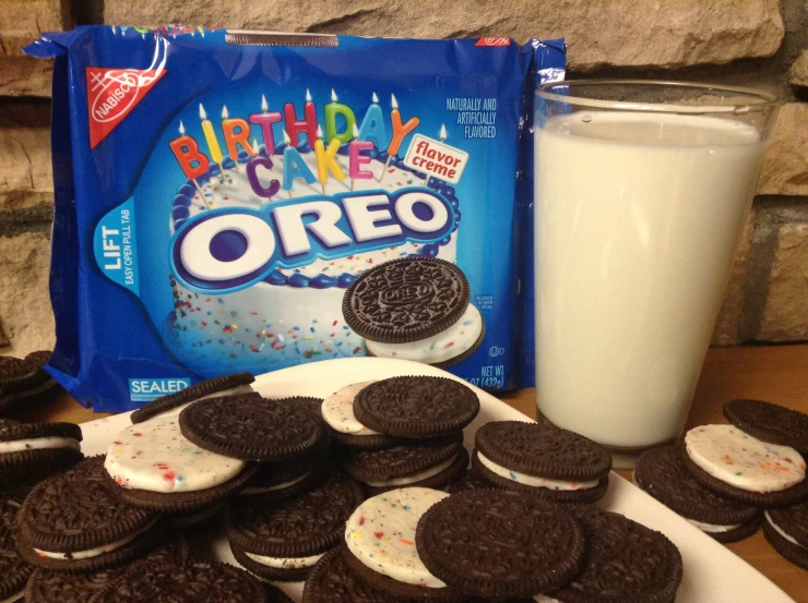 a white plate topped with cookies and oreo cookies next to a bottle of milk