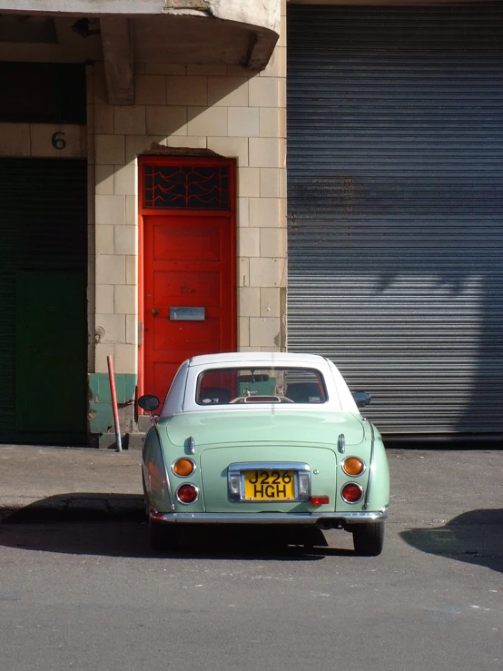 a vintage vw bug parked on the street