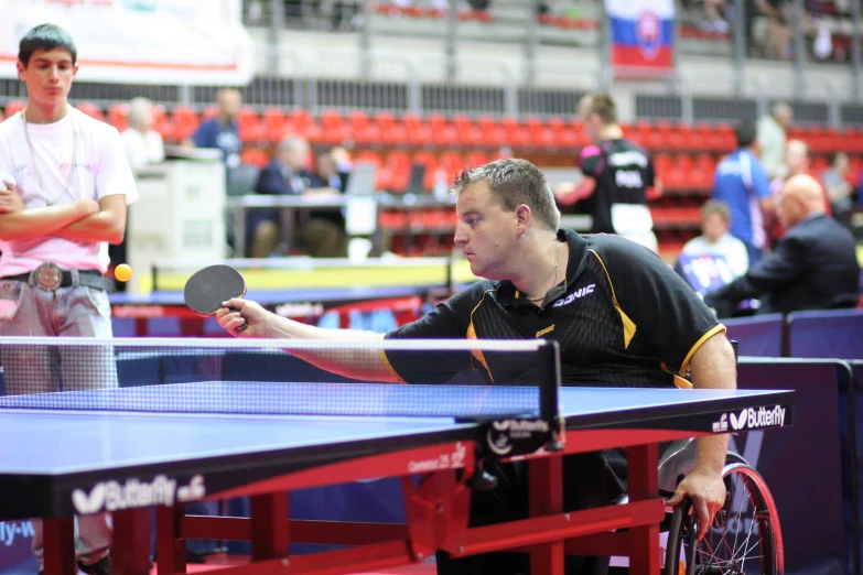 two men playing table tennis on the same team